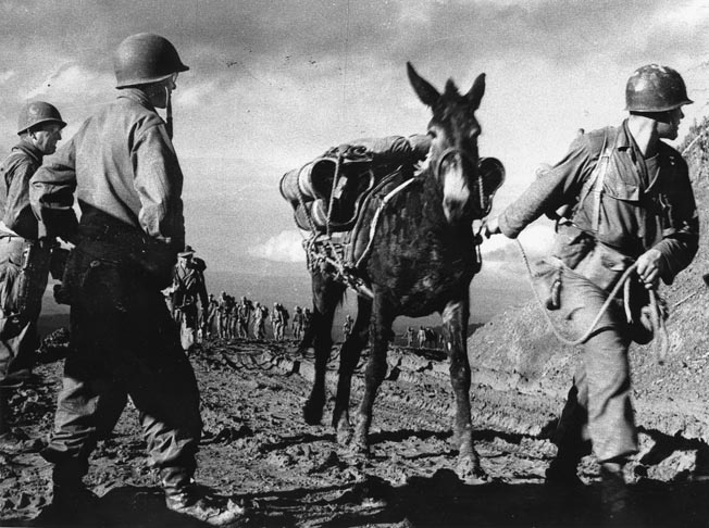  Brigadier General Frank Merrill (far left) watches as his Marauders lead their pack mules over Pangsan Pass along the Ledo Road as they enter Burma, February 1944. Colonel Charles Hunter (second from left), second in command, took charge of the unit after Merrill’s heart attack on March 29, 1944. 