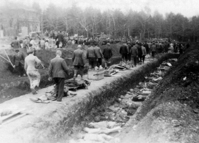 Residents of the town of Nordhausen are forced to view the mass burial of the slave laborers who died at Boelcke Kaserne. Photographed by Dr. Levinson on April 15, 1945.