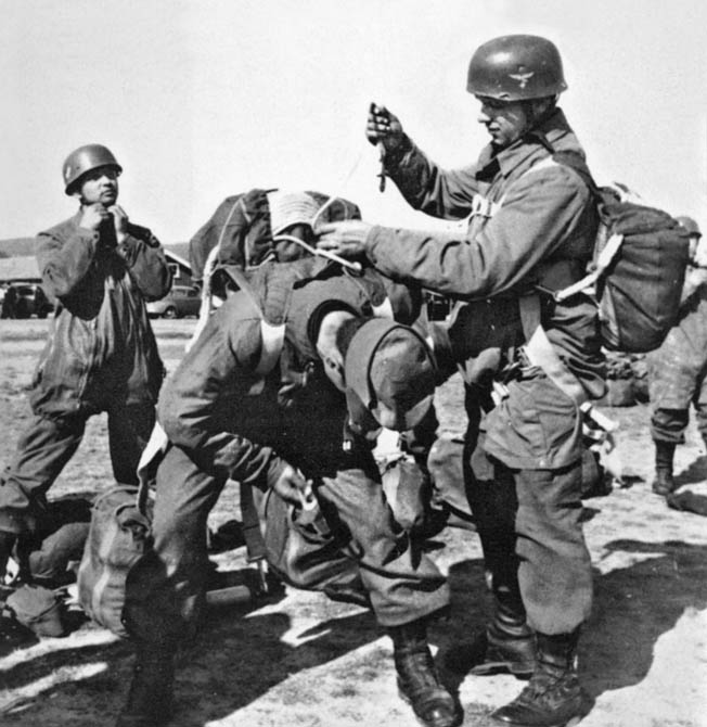 A Fallschirmjäger checks the static line of a fellow paratrooper during a training exercise. As an NCO with combat experience, Statetzny served as an instructor at an officers’ training school. 