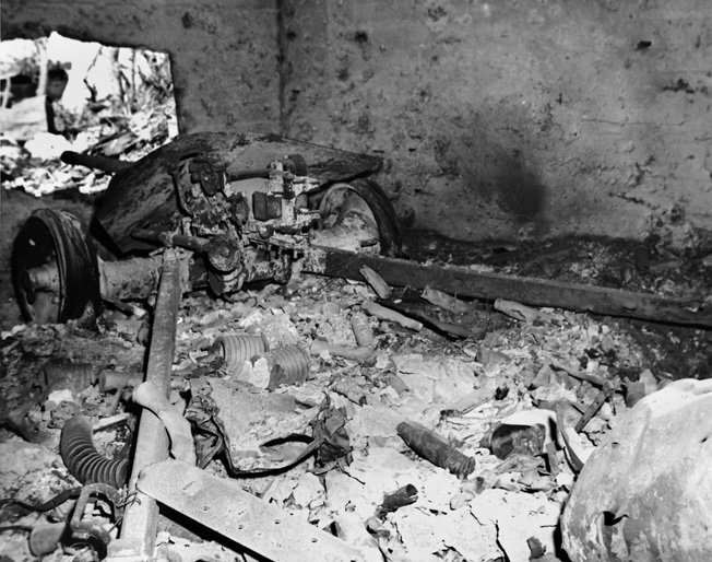 A destroyed Japanese 47mm antitank gun is shown in a photo taken well after the battle. It appears that the shell that knocked out the gun most probably entered through the embrasure.