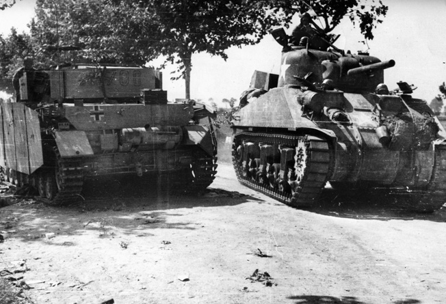 A Sherman tank of the U.S. Fifth Army moves inland after landing at Salerno, passing a German tank knocked out of action during fighting in the area.