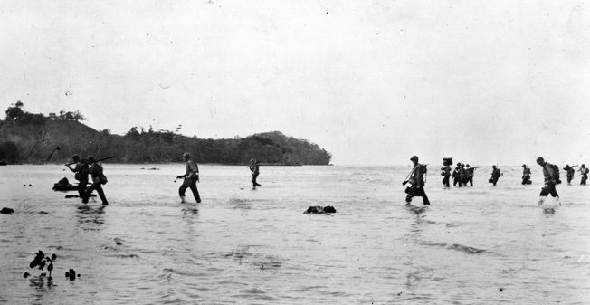 Members of the 2nd Marine Division wade ashore in the shallow waters at Tulagi, August 7 or 8, 1942, against no initial Japanese resistance. The enemy would not remain quiet for long.