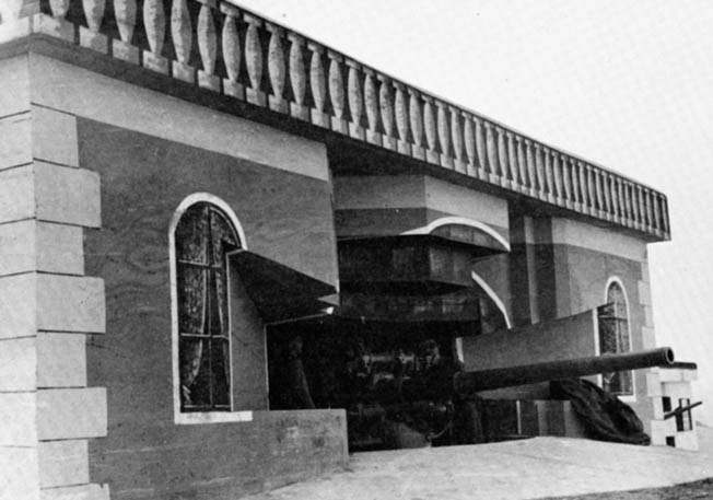 A type 671 casemate, holding a 105mm gun, disguised to look like a seaside home. Note the detailed false windows, curtains, balustrade, and corner stones.