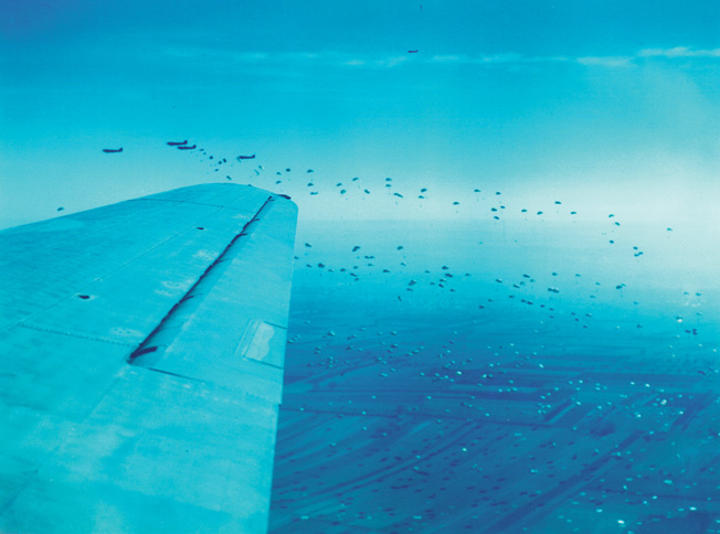 Douglas C-47 transport aircraft fill the European sky as U.S. paratroopers hit the silk. Airborne assaults were risky undertakings during World War II, and the C-47 was a mainstay of the air bridge from England into the war-torn Continent.