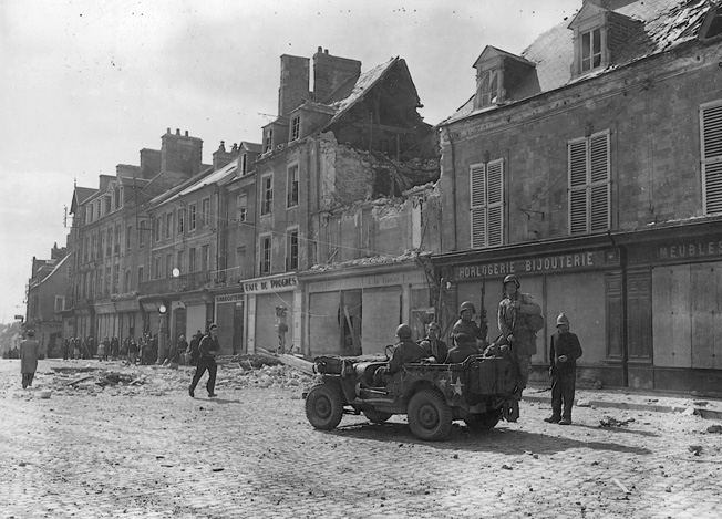 Eight days after the 101st parachuted into Normandy, American soldiers enter the bitterly contested French town of Carentan on June 14, 1944. Troopers of the 101st had taken the village during a tough fight with German air- borne troops and held it against a major counterattack.