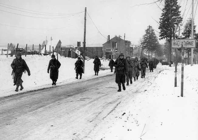 Relieved at last, haggard and war-weary veterans of the epic 101st Airborne defense of Bastogne trudge toward rest and a hot meal. The troopers of the 101st held the encircled crossroads town against repeated German attacks at the height of the Battle of the Bulge. They were ultimately relieved by troops of General George Patton’s Third Army.