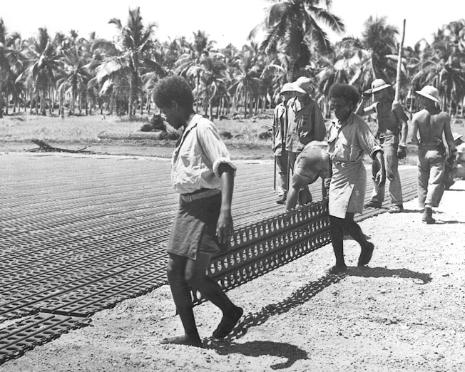 Native and American workers rush to complete the airfield the Japanese had begun to build at Lunga on Guadalcanal. Coast watchers had reported on Japanese progress in building the airfield, and from strategic points around the island warned of impending attacks on the area. The airfield was named Henderson Field.