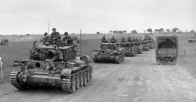 Cromwell tanks of the 2nd Welsh Guards, the armored reconnaissance regiment of the Guards Armoured Division, advance along a dirt road southeast of Caen on July 19, 1944.