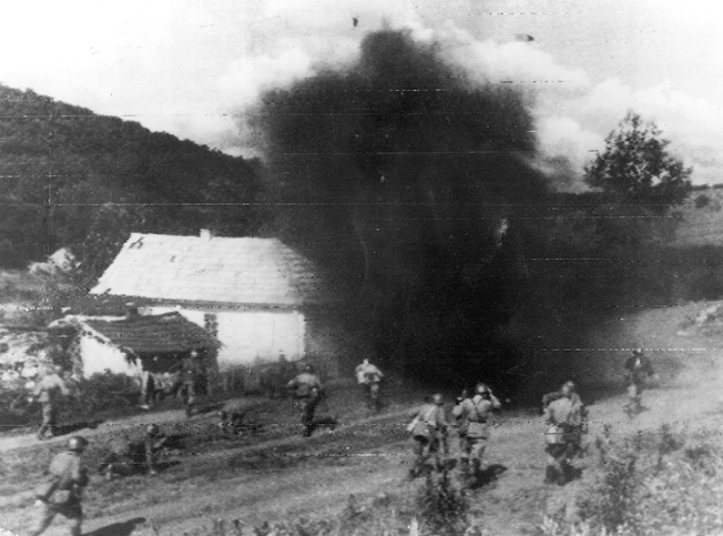 On July 24, 1944, a contingent of Red Army soldiers moves past a damaged farm and toward German positions under constant bombardment from well-placed artillery. The German 88mm cannon was a multipurpose weapon, effective against aircraft, armor, and enemy troops.