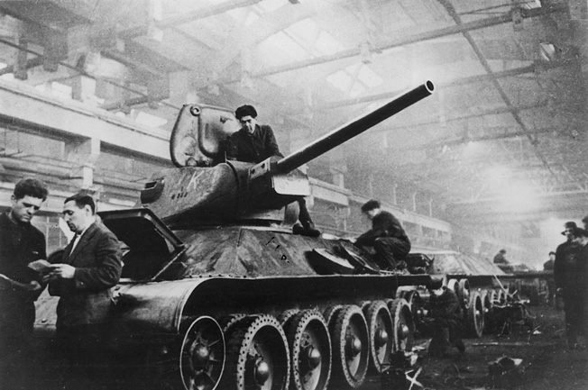 Workers make final adjustments to the turret and chassis of a new T-34 medium tank. Many of these stalwart fighting vehicles were driven straight from the factory into combat.