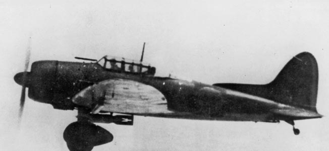 This Japanese Aichi D3A Val dive bomber photographed en route to Pearl Harbor is distinguishable by its fixed landing gear and aiming device that protrudes from the cockpit. The aircraft also has its lethal bomb slung beneath the fuselage. right: American P-40 fighter pilots.