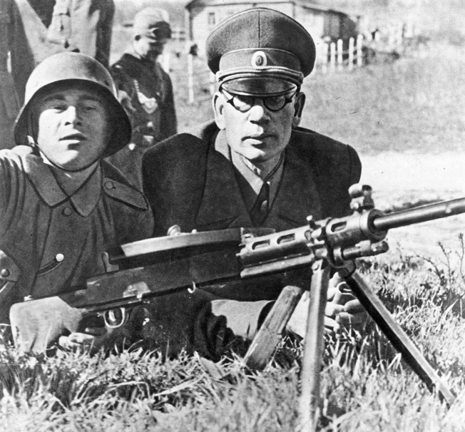 Former Bolshevik commander General Andrei Vlasov (right) turned against Moscow's Stalinist regime and raised an army to fight with the Germans. Her, the general poses with a recruit during training.