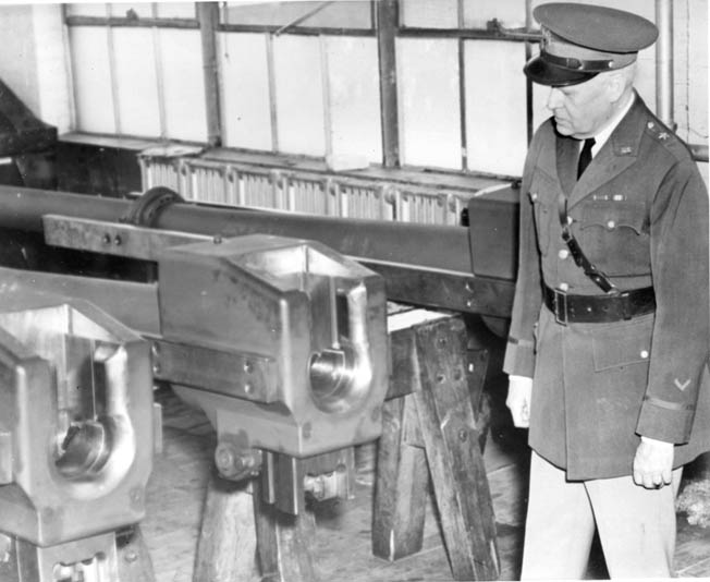 General Alexander Gillespie, who became the commander of the Watervliet Arsenal in July 1940, examines equipment used to fabricate artillery pieces on the factory floor.