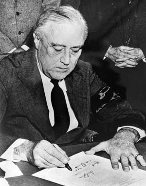 Roosevelt signs the declaration of war against Japan, December 8, 1941. 