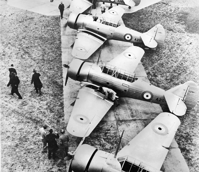 Fresh from the factory, a lineup of newly completed Wirraway aircraft receive the finishing touches from workers before assignment to units of the Royal Australian Air Force. 