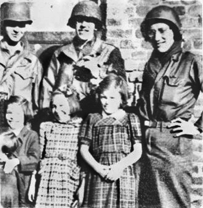 Henry Kissinger (right) with fellow GIs and happy German children. Kissinger, born in Fürth, Germany, later became U.S. Secretary of State.