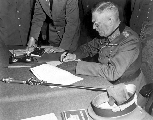 Lieutenant Boehm interpreted during the interrogation of Field Marshal Keitel. Here Keitel signs the ratified terms of surrender in Berlin, May 8, 1945.