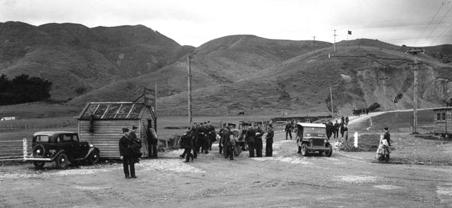  U.S. Marines go about their business at the entrance to Camp McKay, home of the 2nd Marines during their stay in New Zealand. The post was 30 miles away from Wellington, and many Marines found lasting friendships or spouses among the people of the area. Camp Russell, the home of the 6th Marines, was located nearby. 