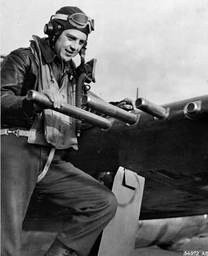 Colonel Hubert Zemke, commander of the famous U.S. 56th Fighter Group in Europe, examines one of the .50-caliber machine guns placed in the wings of his P-47 Thunderbolt fighter.