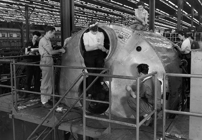 A crew of men and women work on the pressurized cockpit section of one of the big bombers in 1944. More than 600 of the 3,970 B-29s were produced at the Marietta factory which, now owned by Lockheed Martin, still produces aircraft for the U.S. Air Force.