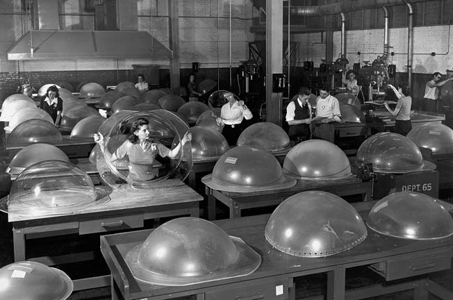 Employees inspect plexiglass “blister" dome windows. The B-29 was produced at four factories around the United States.