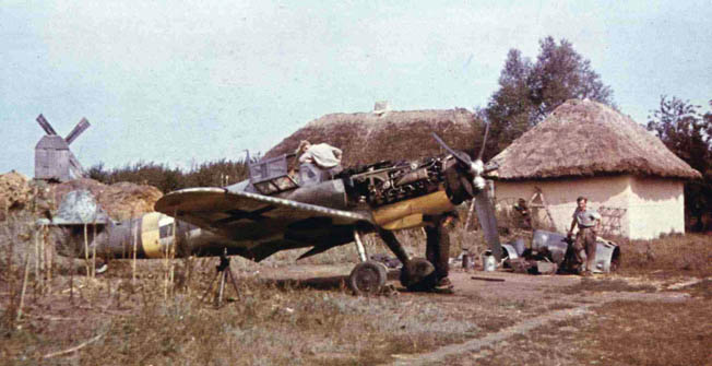 In this rare color photograph, an aircraft believed to be an Me-109 of JG 52 undergoes repairs somewhere in Russia. German maintenance crews struggled mightily to keep their planes in the air due to shortages in spare parts and fuel.