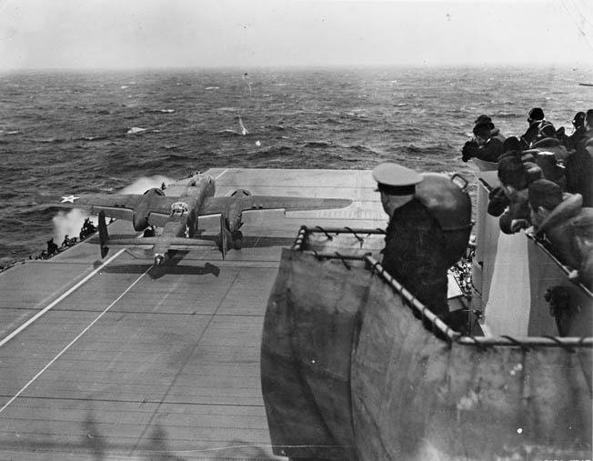 Members of the Hornet crew watch anxiously as one of 16 B-25s lifts off, April 18, 1942.