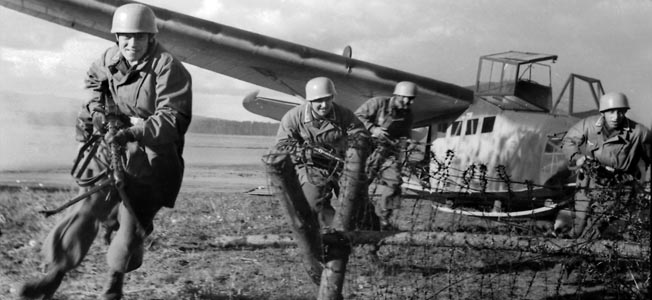 Fallschirmjägers exit a DFS 230 glider during training. This type of glider was used during the assault on Belgium’s Fortress Eben-Email and the invasion of Crete.