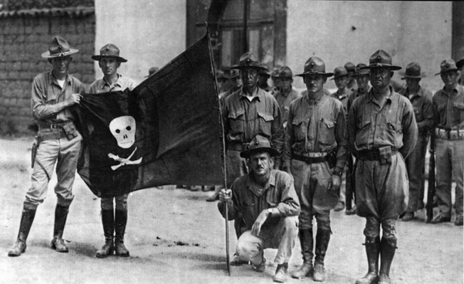 Members of the garrison at Ocotal display a captured Sandinista flag in July 1927.