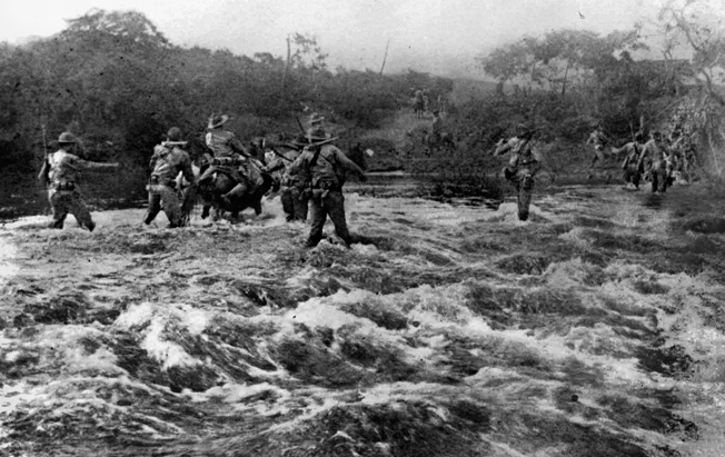 A Marine patrol crosses a swift-running river in Nicaragua. The Marines had to battle the elements as well as the insurgents.