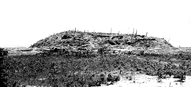 A black and white photograph of Sugar Loaf Hill, one of the places the good fortune of U.S. Marines in Okinawa came to a crashing halt. 