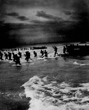 Landing craft unload their cargoes of U.S. Army troops on the beach in North Africa during the opening hours of Operation Torch on November 8, 1942. These troops are coming ashore south of Port Lyautey, where heavy surf played havoc with the initial landings, damaging numerous landing craft and disrupting the timetable for the movement inland toward the earliest Torch objectives.