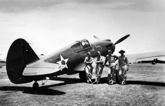 Several American pilots pose at Clark Field in August 1941. Standing left to right are: Carl Gies, Max Louk, Erwin Crellin, and Varian Kieler.